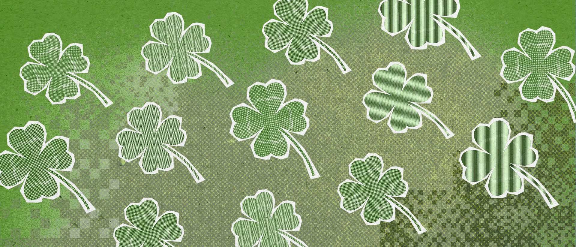 A banner of cut-out four-leaf clovers on a textured green background.