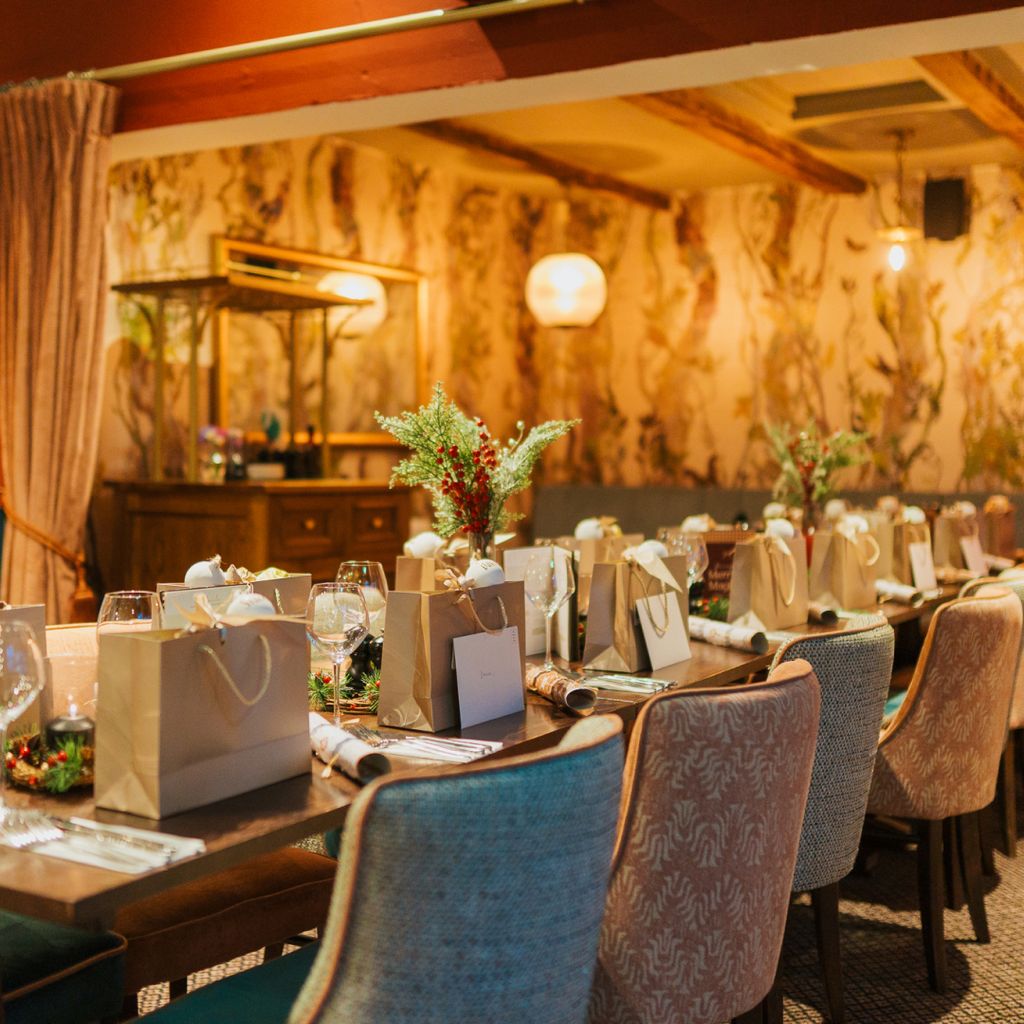 A luxury Christmas dinner table with personalised gift bags, waiting for content creators to arrive.