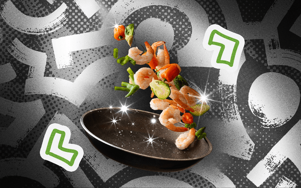 A colourful prawn stir-fry being tossed with code brackets around it.